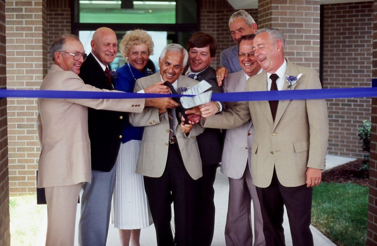 people cutting a ribbon